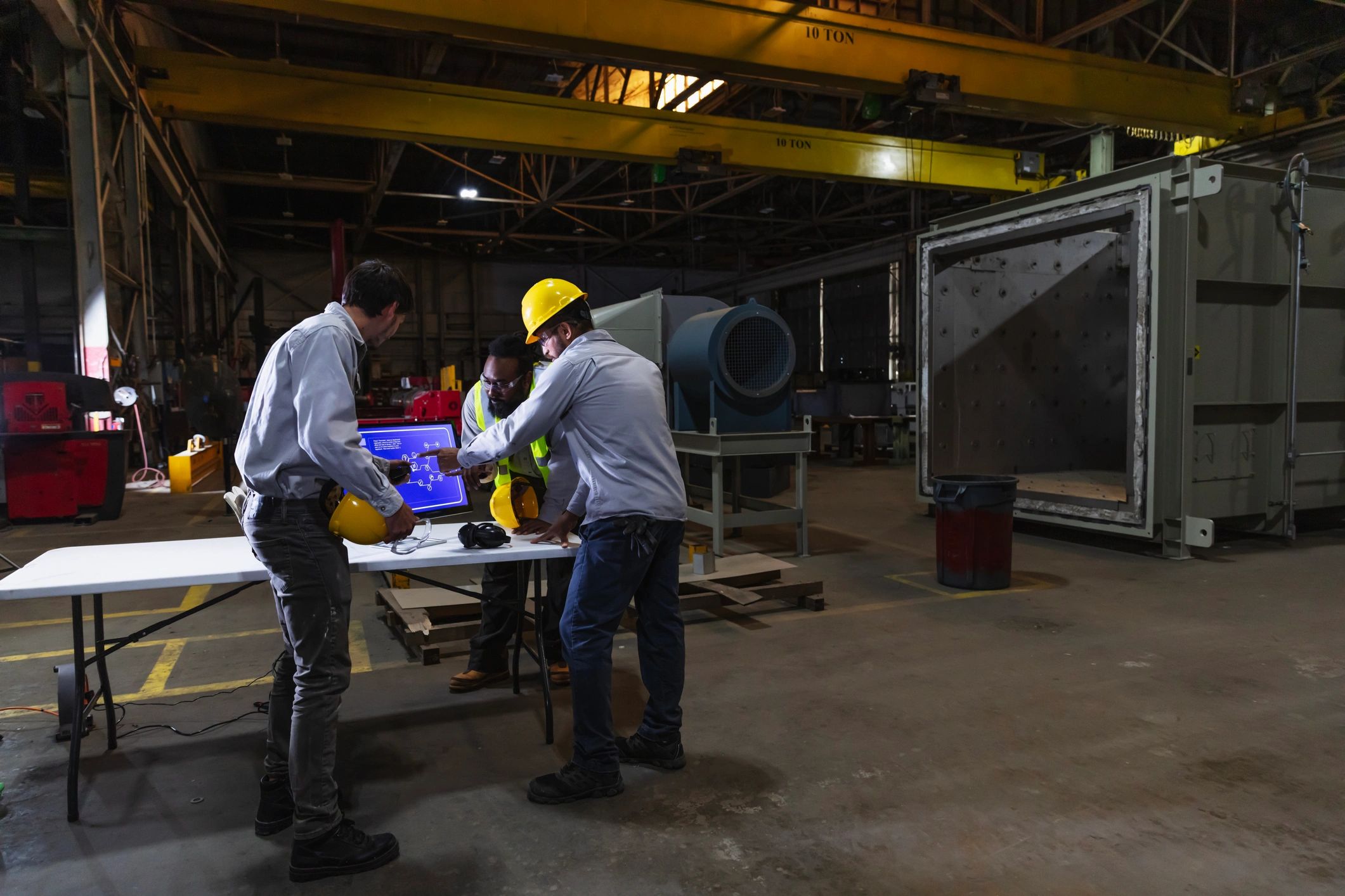 Engineering team reviewing technical systems in an industrial workspace